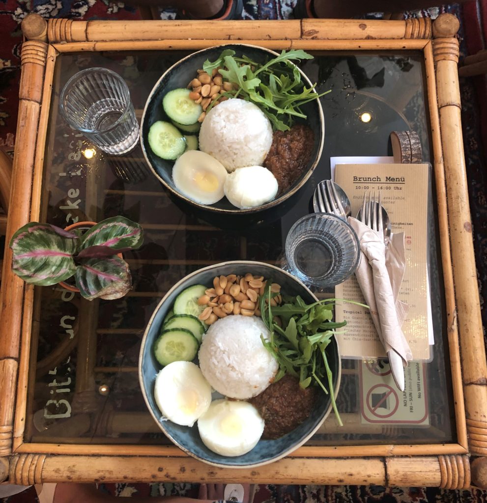 Two plates of Nasi Lemak served on a table. 