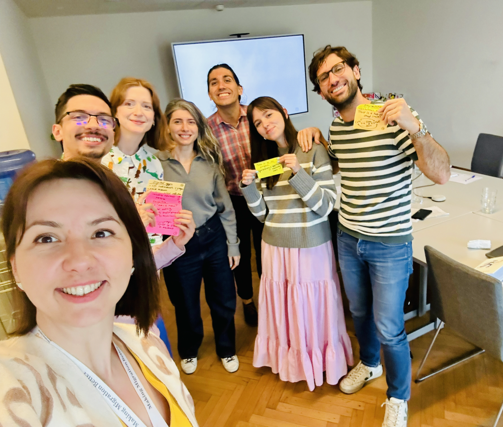 EUDiF team standing together smiling with handwritten notes in Post-it papers.