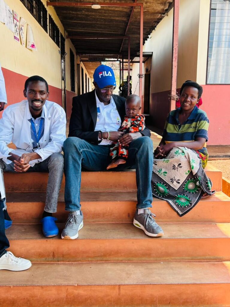 three adults and a child sit on a staircase.
