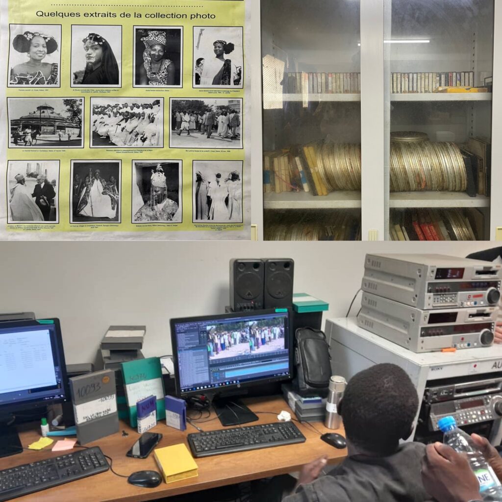 Image of a person sitting in front of a computer. We can see in the background some rolls of old video tape. 